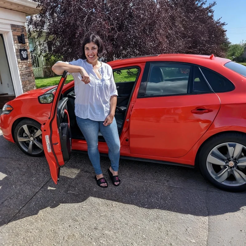 Jessica L. with their approved Red Sedan